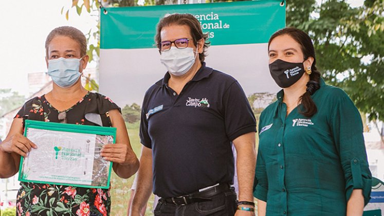 La directora de la ANT, Myriam Martínez, y el ministro de Agricultura, Rodolfo Zea, entregando los documentos de propiedad.