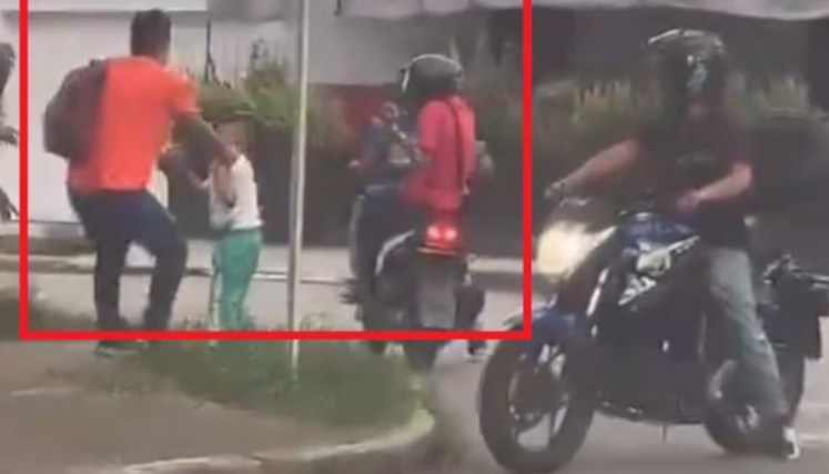 n medio de un robo delincientes apuntan con arma a un menor